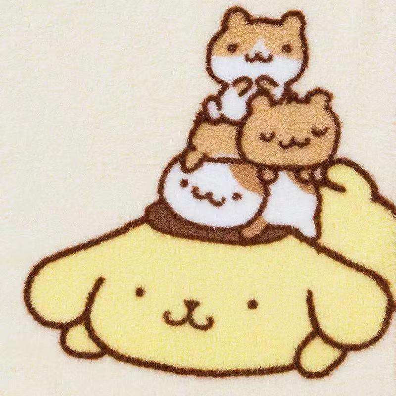 Close-up of Pompompurin and friends stacked atop each other on a facial towel, showcasing intricate detail.