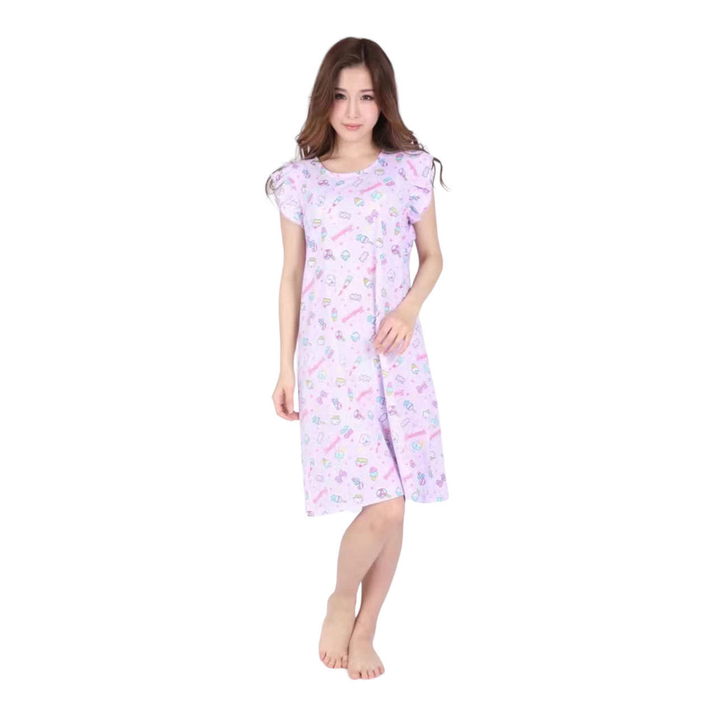 A front view of a woman wearing a pastel Sanrio print lounge dress, featuring adorable character motifs and a comfortable mid-length design