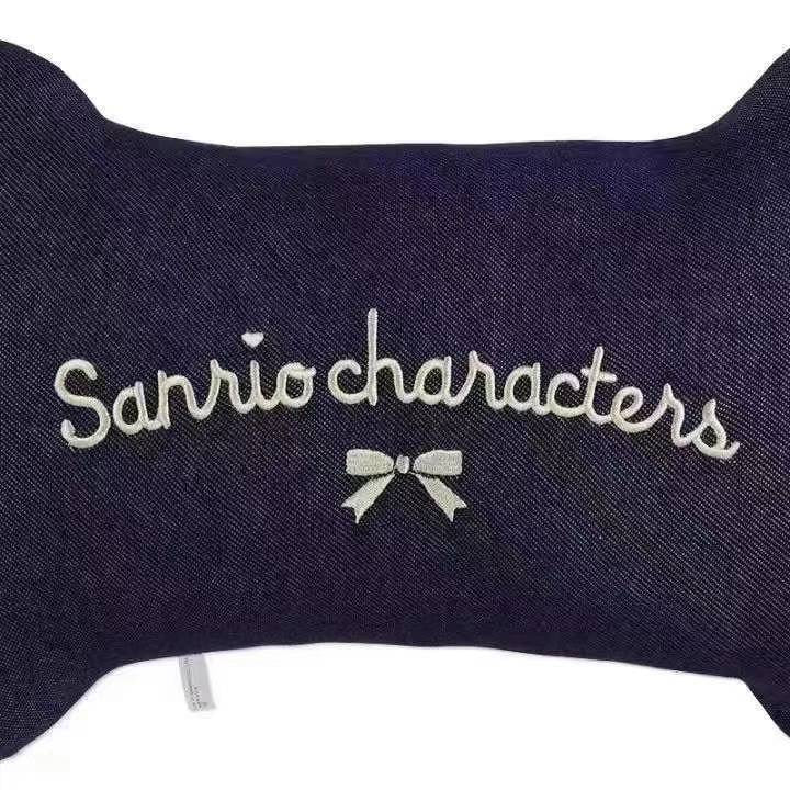 Detailed image of the back of the Sanrio characters neck pillow with the logo in elegant white script and a cute bow accent