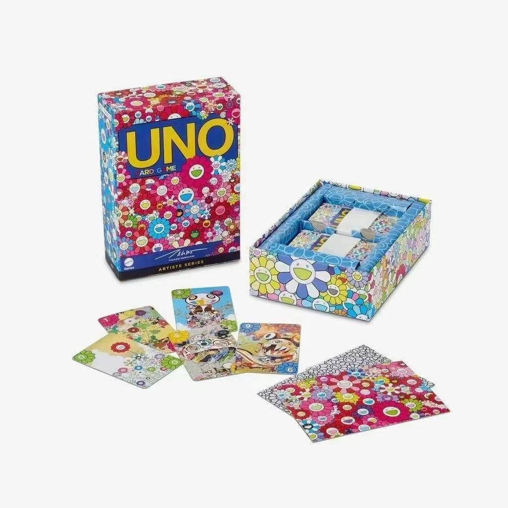 Colorful Takashi Murakami UNO Artiste Series box with vibrant flower designs, alongside an open box displaying equally vibrant playing cards.