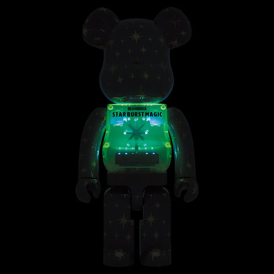 The Bearbrick Star Burst Magic figure glowing in the dark, with its stars and internal design illuminated to create a magical, cosmic effect