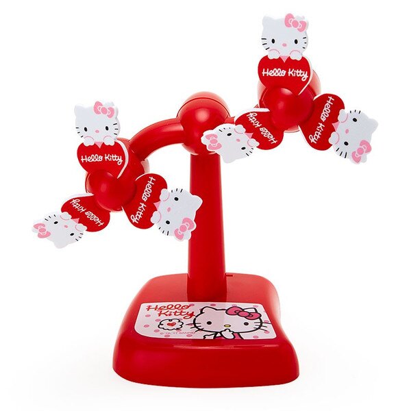 Sanrio Hello Kitty windmill toy in motion with blurred red blades on a red stand with Hello Kitty illustration.