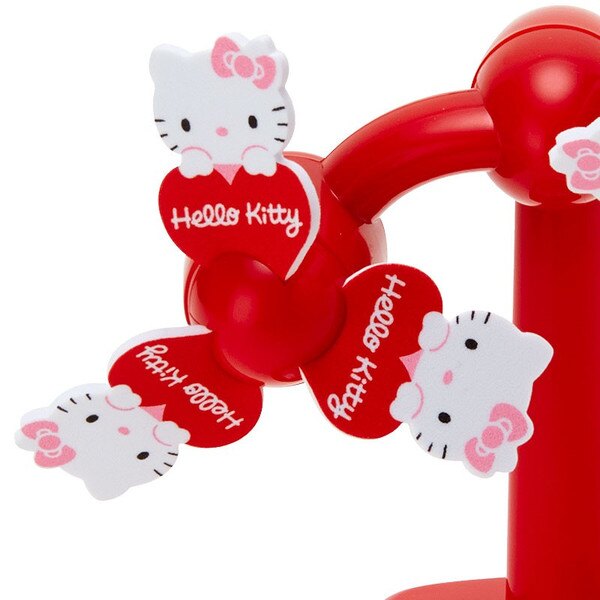 Sanrio Hello Kitty stationary windmill toy with red blades featuring Hello Kitty faces and hearts on a red base