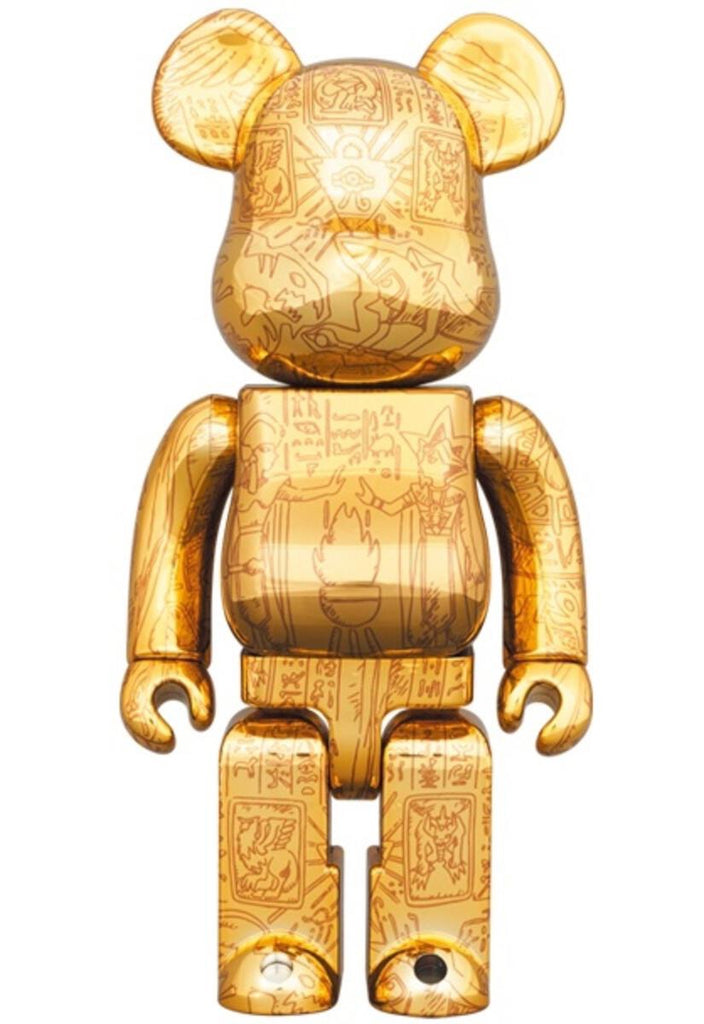 Golden Bearbrick figure with intricate Yu-Gi-Oh Millennium Puzzle engravings