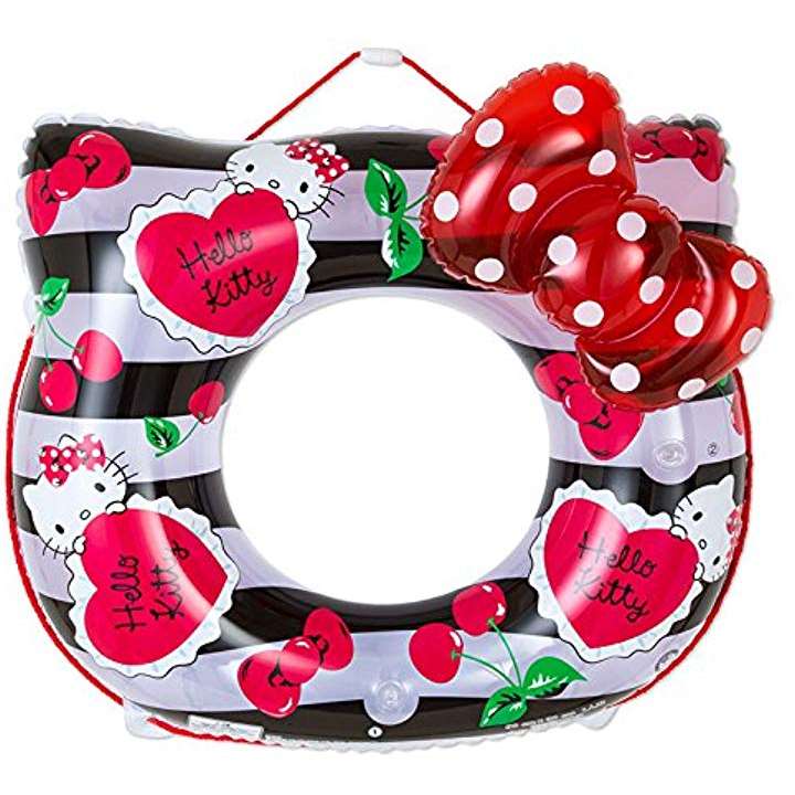 Colorful Sanrio Hello Kitty inflatable swimming ring adorned with red hearts, cherries, and Hello Kitty motifs against a black and white striped background
