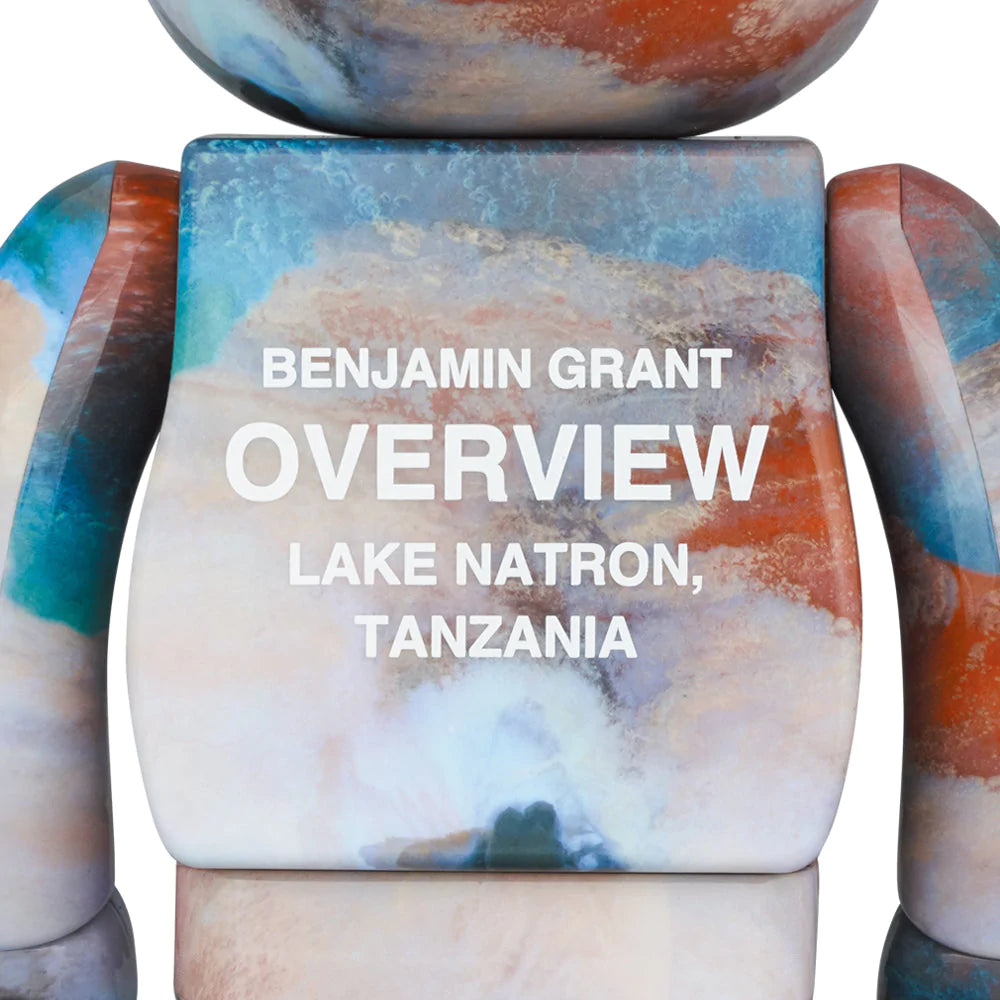 Back view of Bearbrick figures in 400% and 100% sizes, featuring aerial imagery of Lake Natron by Benjamin Grant from the OVERVIEW series