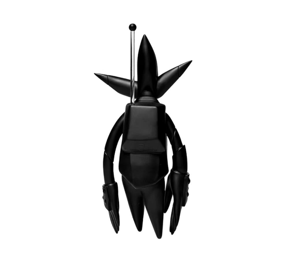 Rear view of the Futura Laboratories FL-001 vinyl figure, emphasizing its aerodynamic shape and unique fin structure.