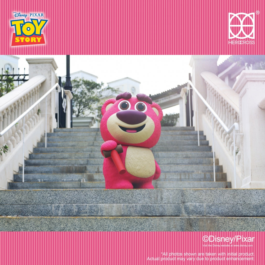 Jumbo Lotso Huggin Bear figure posed on stairs, featuring adjustable eyebrows and a strawberry scent.