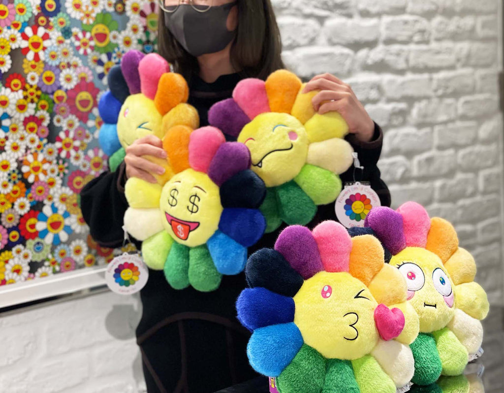  A collection of Takashi Murakami Flower Plush designs, including Emoji variations, displayed in different Emojis with vibrant colors and iconic Murakami style